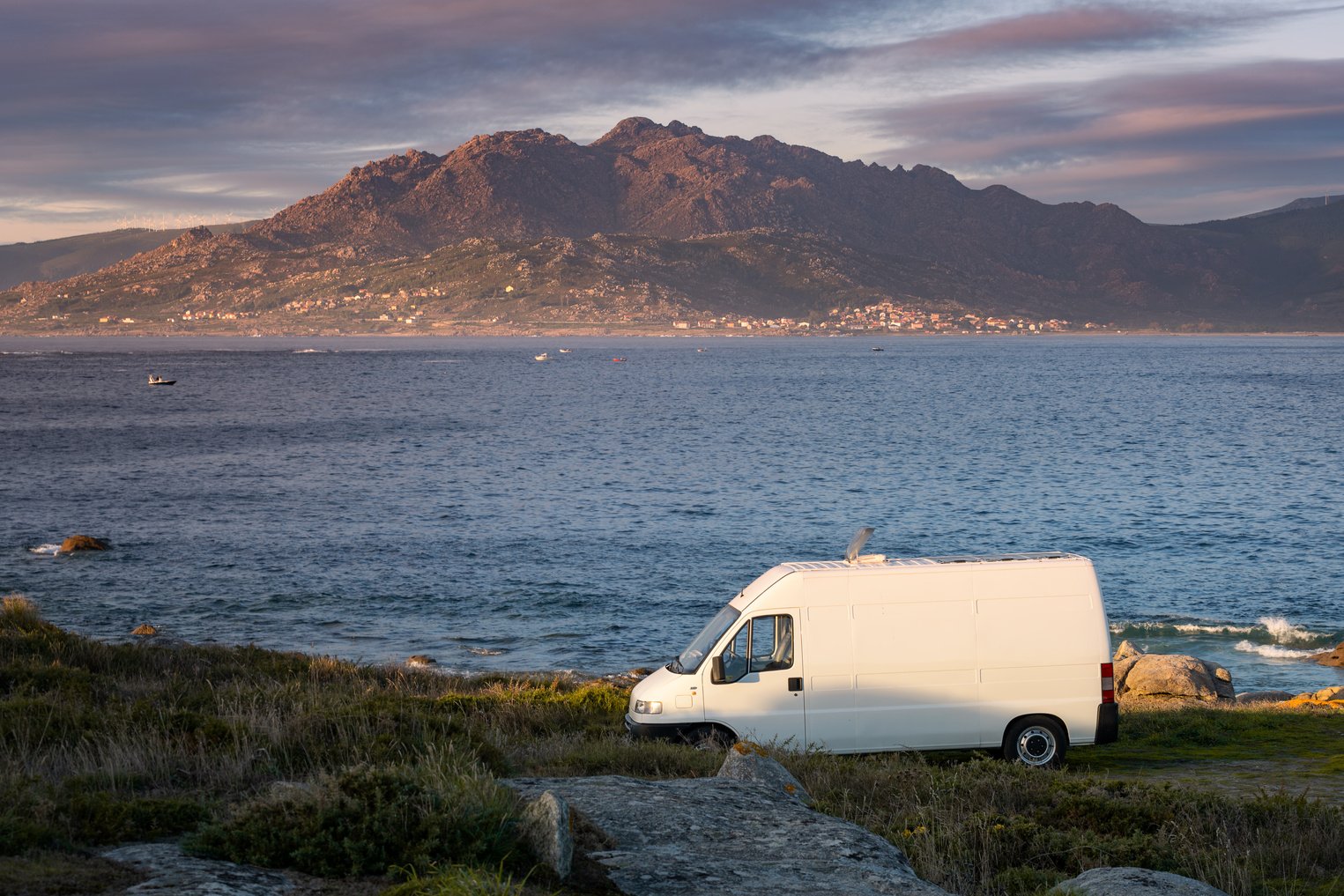 Camper van motorhome with solar panels view on a sea landsca